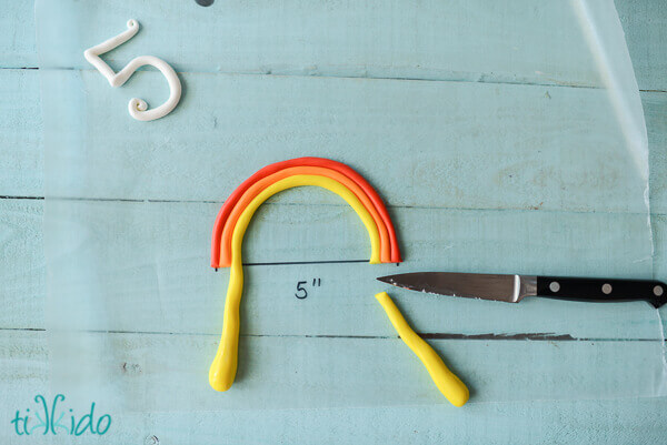 Gum Paste being formed into a rainbow cake topper.