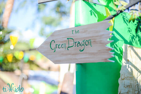 Faux wood sign pointing the way to the Green Dragon at the Lord of the Rings birthday