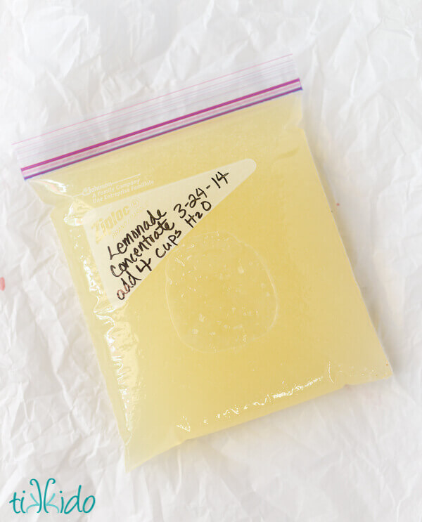 Bag of homemade frozen lemonade concentrate on a white paper surface.