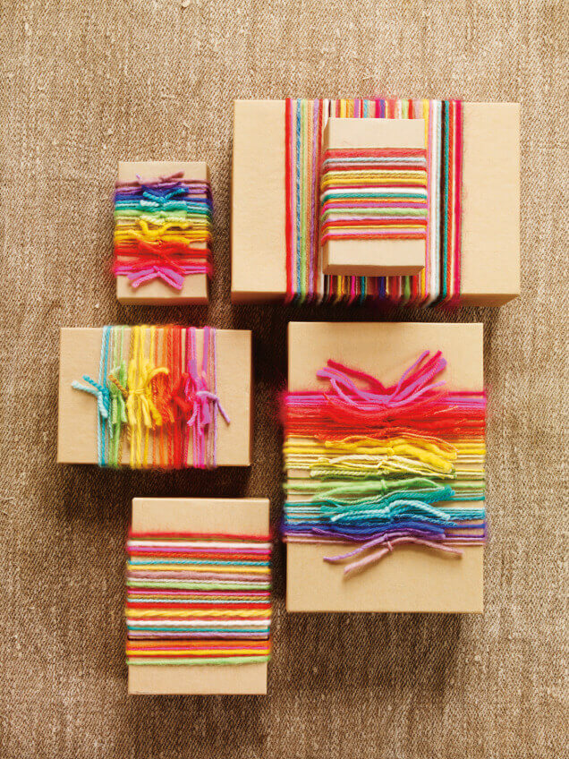 Brown paper packages embellished with colorful yarn.