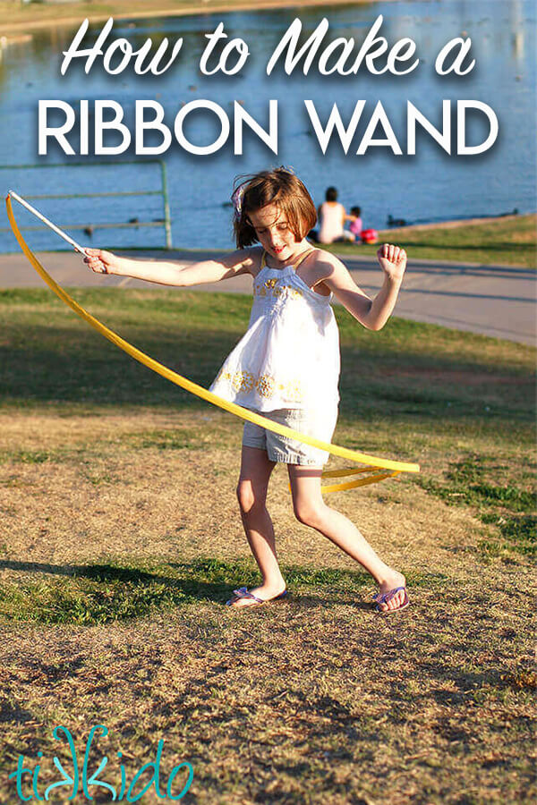 How to Make a Ribbon Wand Little girl in a park playing with a DIY ribbon wand, with text overlay reading "How to Make a Ribbon Wand."