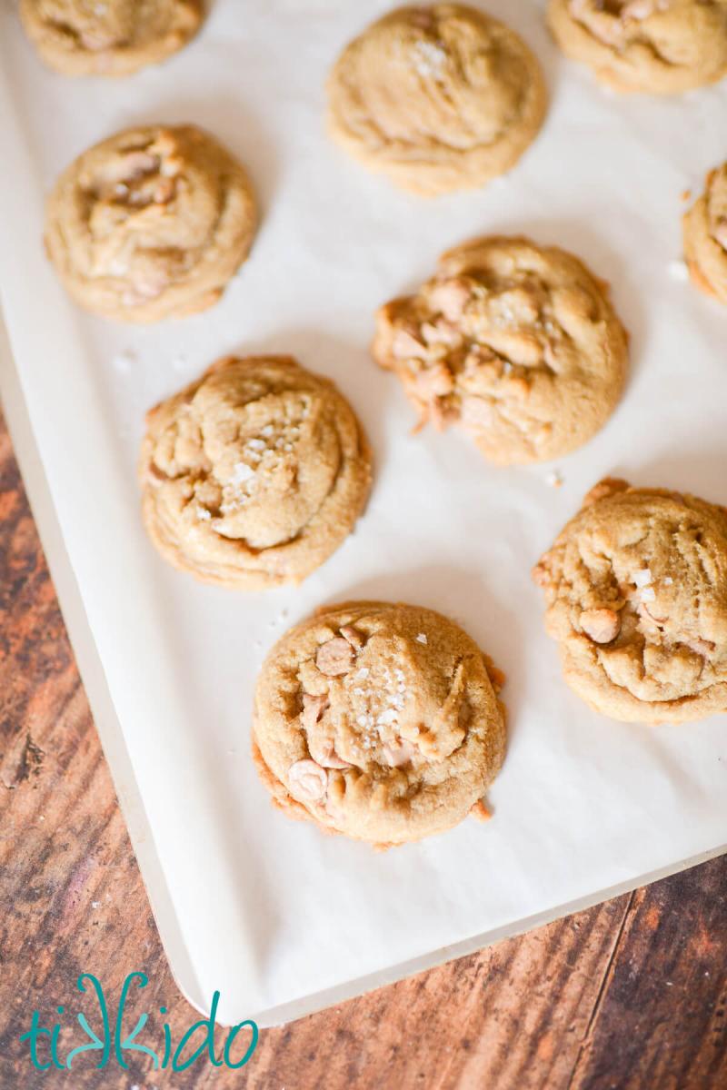 Salted Caramel Cookies Salted caramel cookies, freshly baked on a parchment lined cookie sheet.