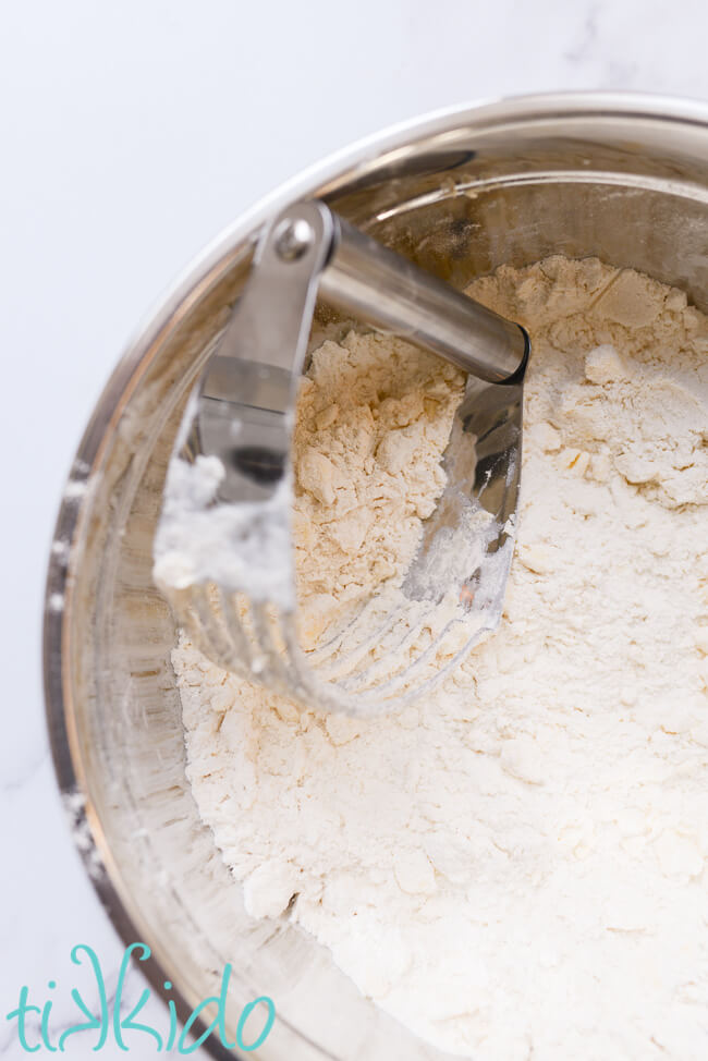 Easy Scones Recipe Ingredients for an easy scones recipe being combined with a pastry cutter in a metal bowl.