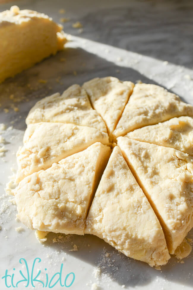Easy Scones Recipe Circle of scones dough shaped in a circle and cut into eight wedges.