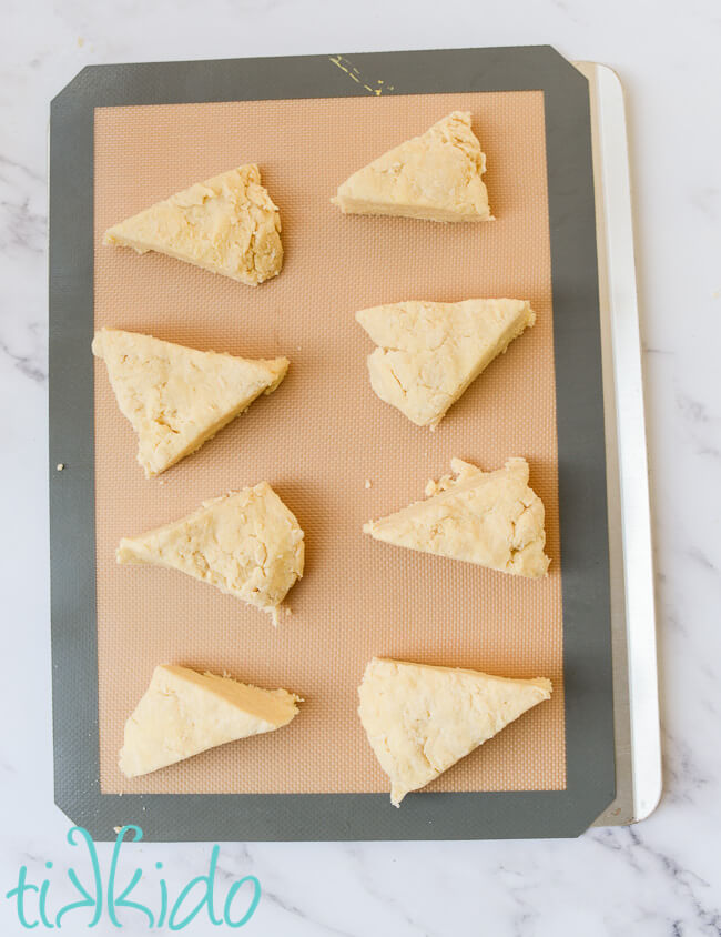 Easy Scones Recipe wedge shaped scones dough on a silpat lined baking sheet.