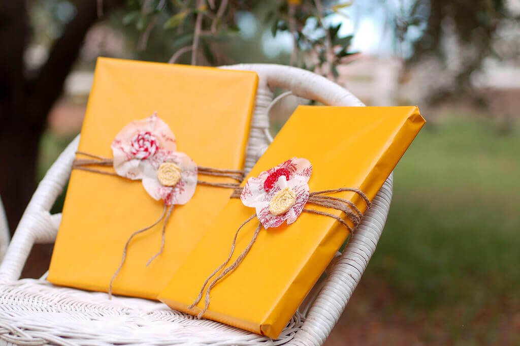 Twisted Fabric Flowers Easy fabric flowers made with twisted scrap fabric used as gift toppers on two presents.