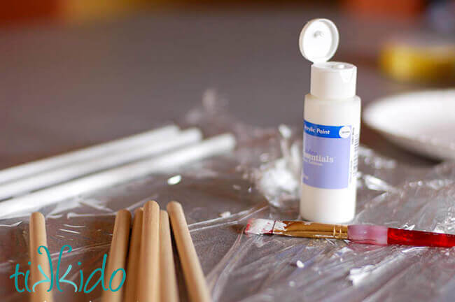 Ribbon Wand Wooden dowels being painted for ribbon wands.