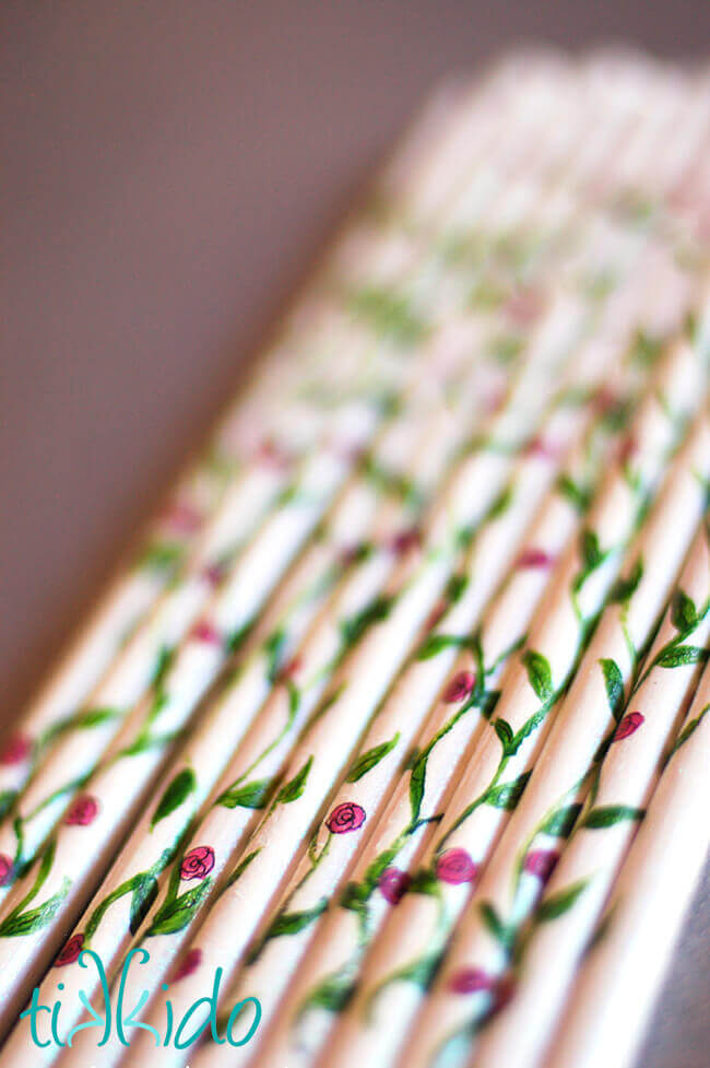 DIY Ribbon Wand Wooden dowels painted white, and with a climbing rose motif to serve as the wands for DIY ribbon wands.