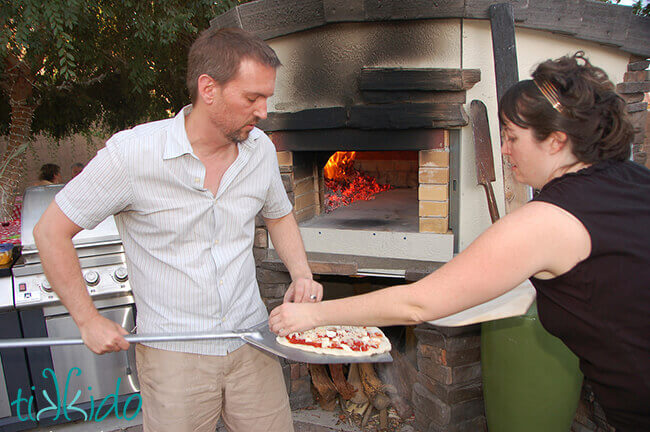 Pizza being made in a wood fired pizza oven.